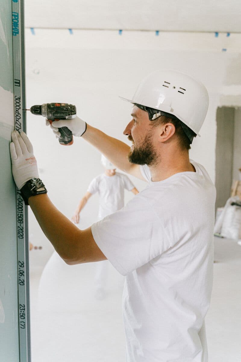 Trade professional drilling drywall on site